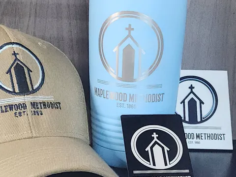 Engraved tumbler, embroidered cap, pen, and metal cards made for a church client